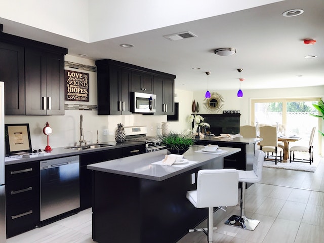black and white kitchen with stainless steel appliances