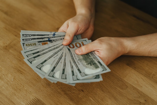 hands holding cash all fanned out