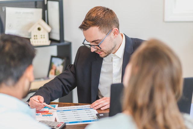 real estate agent looking over mortgage options with buyers