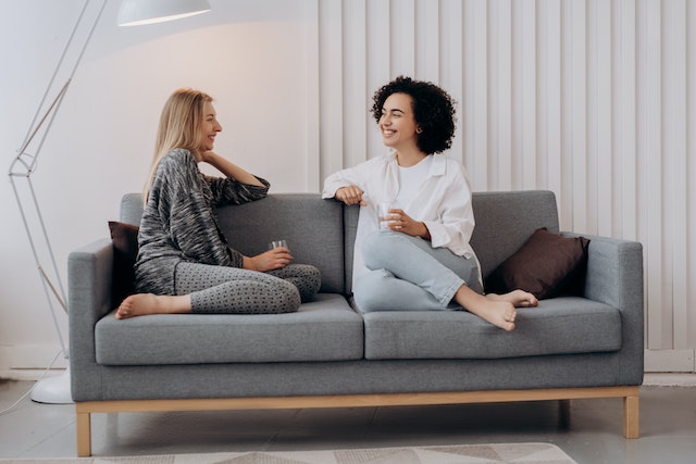 two-tenants-sitting-on-couch-talking